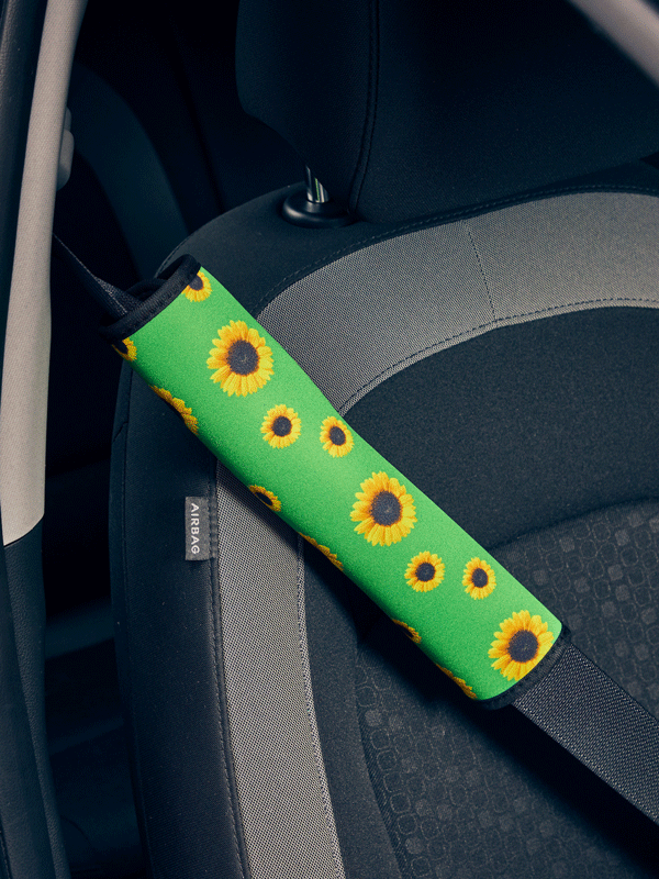 Green with sunflowers seatbelt cover on seatbelt.