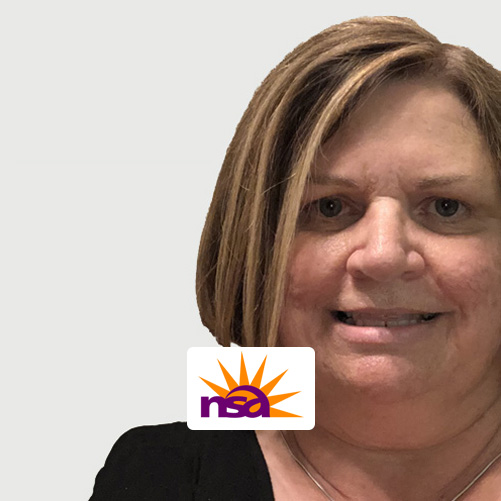 Pam Mertz smiling, with the NSA logo