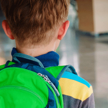 Back of boy with green backpack