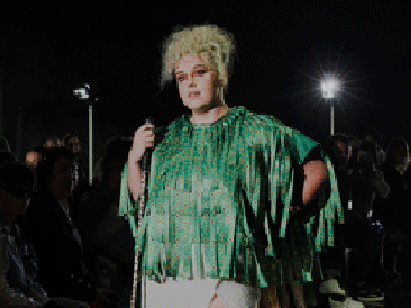 Tilly, model wearing a cape made out of Sunflower lanyards