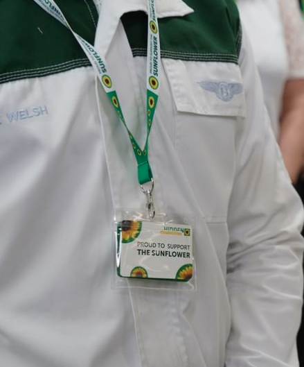A Bentley employee wearing the I Support Sunflower lanyard