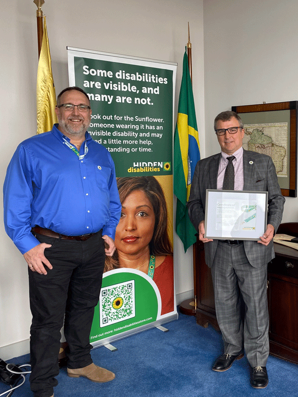 Two men, one holding a Sunflower certificate