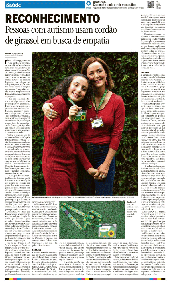 Página de jornal mostrando artigo e foto de Flavia e Felicia vestindo suéteres vermelhos