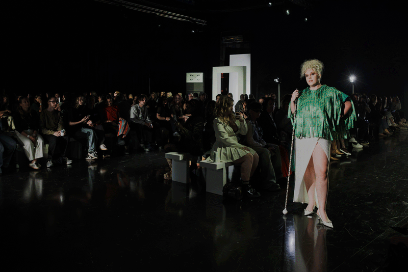 Victoria Jenkins with the festival cape created from part of the world-record Hidden Disabilities Sunflower lanyard at Manchester Fashion Week.