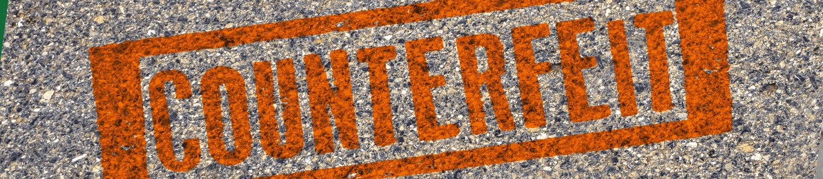 Text saying counterfeit on a pavement background