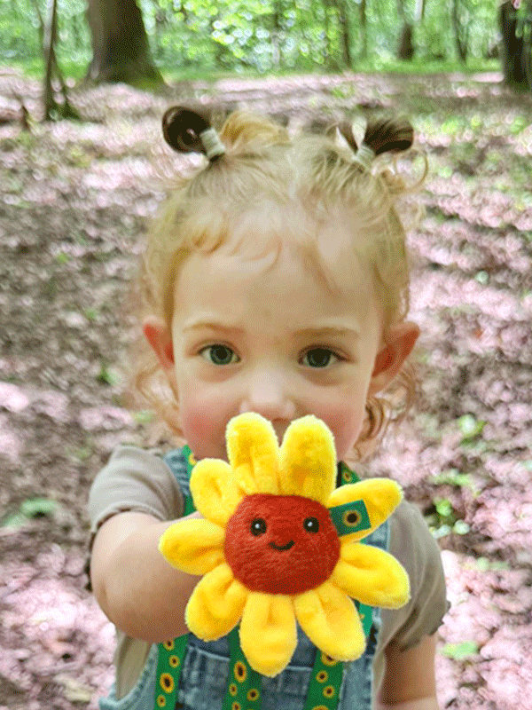 Young child holding Sunny plushy
